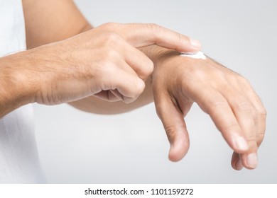 Man Applying Hand Cream On White Background, Closeup