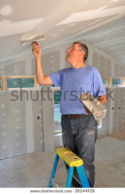 Man Applying Joint Compound Seams Between Stock Image