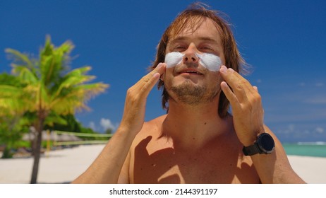 Man Is Applying Sunscreen To His Face. Sun Protection Concept