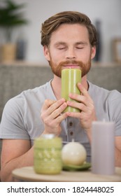 Man Appreciating The Aroma Of A Candle