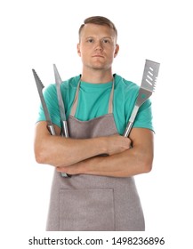 Man in apron with barbecue utensils on white background