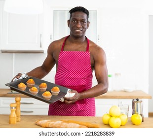 Man In Apron Holding Baking Sheet With