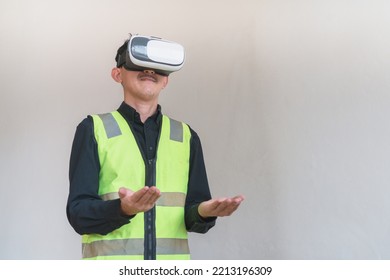 Man Architect or Engineer designer using VR headset and Using Gestures for design working in studio short  grey background.  - Powered by Shutterstock - Get 15% off with code: PIKWIZARD15