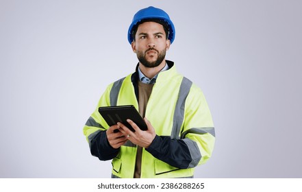 Man, architect and thinking with tablet for construction or planning against a gray studio background. Male person, contractor or engineer in wonder, thought or plan with technology for architecture