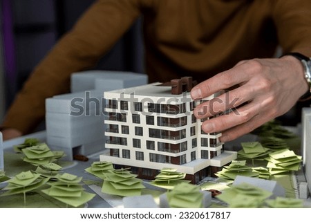 Man architect working in office on creation of new residential complex designing layout of buildings [[stock_photo]] © 