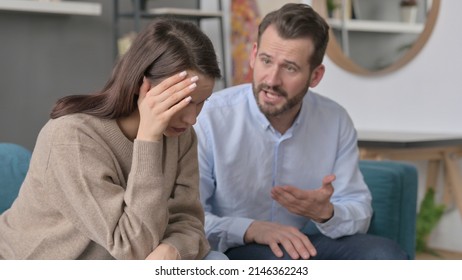 Man Arguing while Women Feeling Stressed on Sofa  - Powered by Shutterstock