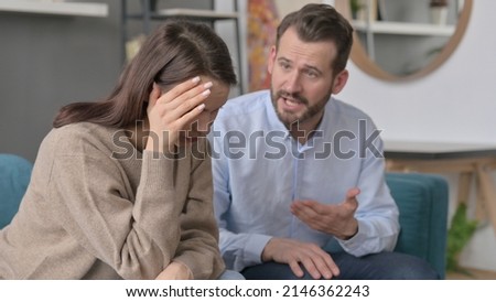 Man Arguing while Women Feeling Stressed on Sofa 