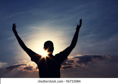 Man With Arms Wide Open Is Looking At The Sky