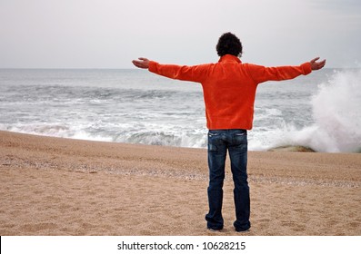 Man With Arms Wide Open In A Tropical Beach