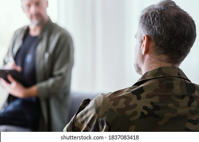 Man in army uniform trating his fears during psychological session