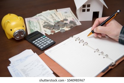 A man arranging receipts. Home Economics Concept. - Shutterstock ID 1040985967