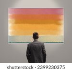Man in the art gallery looking at paintings, abstract contemporary art concept