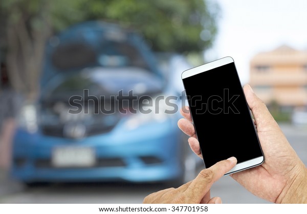 Man asia hand hold and touch\
screen smart phone , blur of cars on the road high way\
background