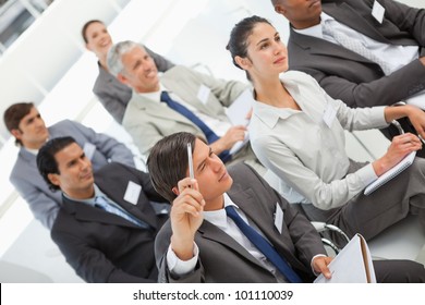 A Man Is Asking A Question At A Business Meeting