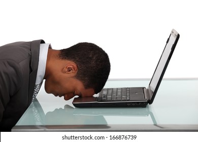 Man asleep on laptop