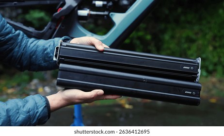 Man assembiling powerful ebike bicycle batteries in hands