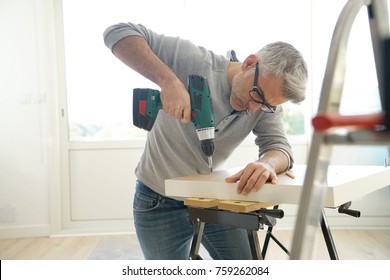 Man Assembling DIY Furniture Using Electric Drill