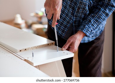 Man Assembling Flat Pack Furniture