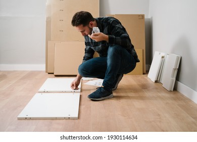 Man Assembling Furniture For His New House. Do It Yourself Furniture Assembly.