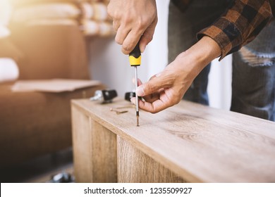 The Man Assembling New Furniture At His Home.