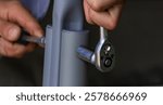 A man is assembling a swing. Selective focus.