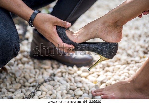 Man Assisting Woman Putting On Her Stock Photo (Edit Now) 641835580