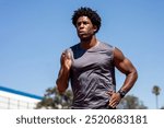 Man athlete sprinting. Sprinter starting to run at stadium. Muscular sportsman outdoors running. Man sprinter running and exercising. Athlete starting running on the track.