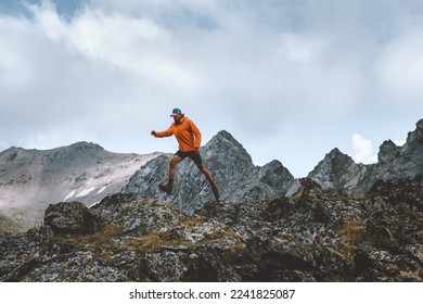 Man athlete trail running outdoor in mountains travel hiking adventure hobby skyrunning sport activity summer vacations healthy lifestyle concept - Shutterstock ID 2241825087