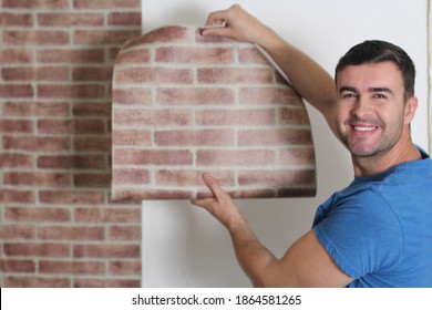 Man Attaching Brick Wall Style Paper 