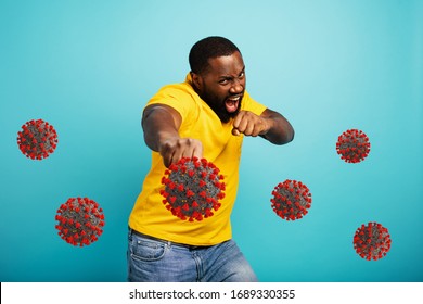 Man Attacks With A Punch The Covid 19 Coronavirus. Blue Background