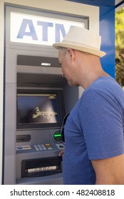 Man At Automatic Teller Machine. Mature Man By An Atm Machine