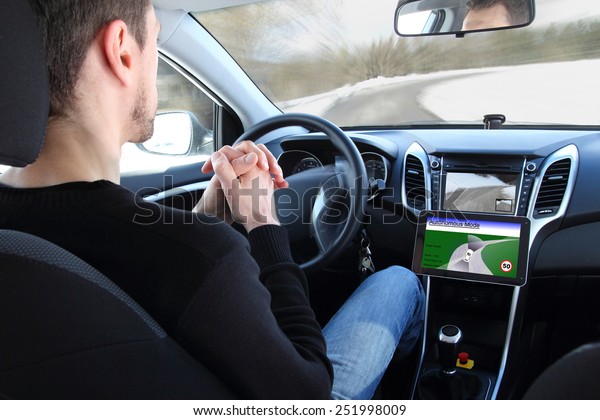A man in a\
Autonomous driving  test\
vehicle