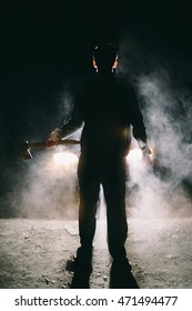 A Man With An Ax Iin The Headlights