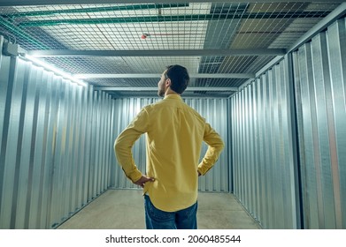 Man With Back To Camera In Empty Iron Garage