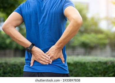 A Man Back Pain After Exercise Concept.It Happens Often In Athletes Practice Overtain,Lifting Heavy Objects Or Office Syndrome.A Muscle Inflammation Concept.