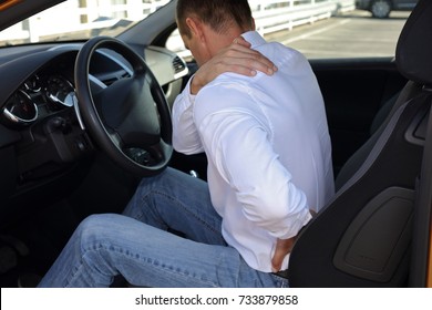 Man With Back Pain After Long Car Drive. Pain Relief And Health Care Concept.