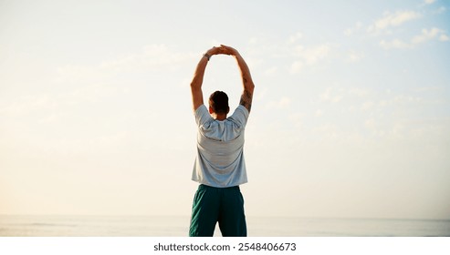 Man, back and stretching with fitness by beach for workout, breathing exercise or health and wellness in nature. Active, male person or runner with warm up for training or fresh air by ocean coast - Powered by Shutterstock