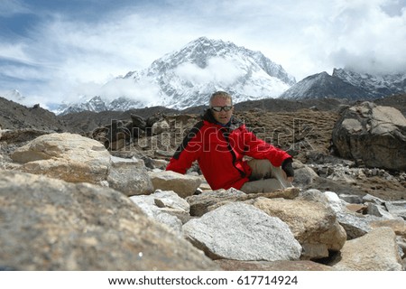 Similar – Image, Stock Photo Backpacker resting.