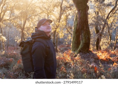 Man with backpack exploring nature during a beautiful forest hike