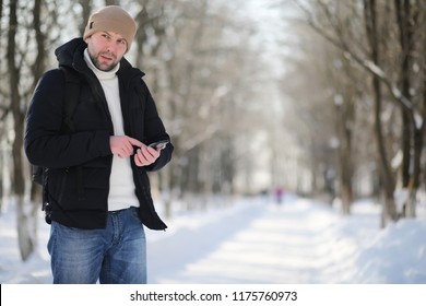 A man with a backpack frosty winter day - Shutterstock ID 1175760973