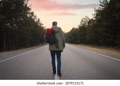 Man With Backpack Going Along Road Near Forest, Back View