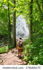 Man With Backpack Hiking In In The Forest On Summer Vacation Trip. Crabtree Falls Just Off The Blue Ridge Parkway. Blue Ridge Mountains, North Carolina, USA.