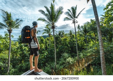 A Man With A Backpack Looking At The Jungle In Lombok, Indonesia
