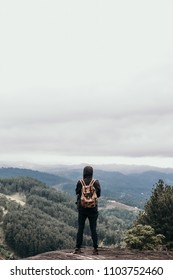 man with backpack looking at the view