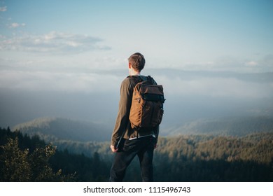 Man with a backpack overlooking mountain range