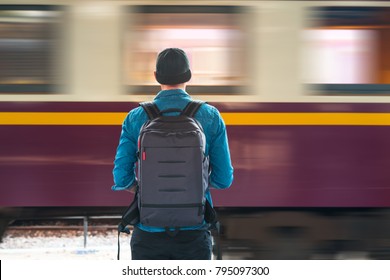 Man with backpack waiting for a train