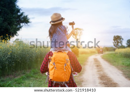 Man backpacker enjoy child on the shoulder.