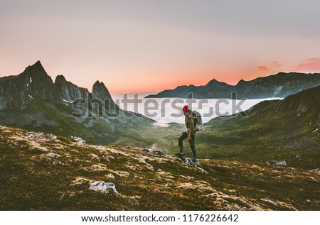 Man backpacker hiking in mountains alone  outdoor active lifestyle travel adventure vacations sunset Norway landscape