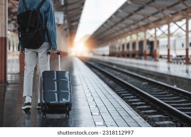 man backpacker traveler plan safety trip low cost budget summer holiday after coronavirus. Empty tourist on train railway platform. Use bus train sustainable environmental friendly transport..