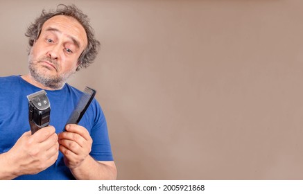 Man With Bad Hair Day Facing Decision Comb Or Cut With Hair Trimmer. Copy Space To The Right